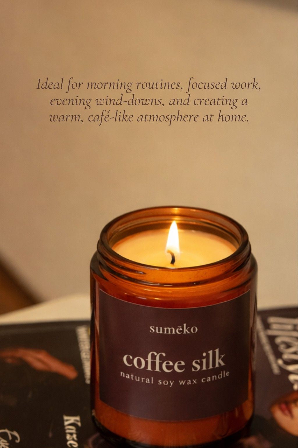 Sumeko coffee silk candle with a lit flame on a blurred background