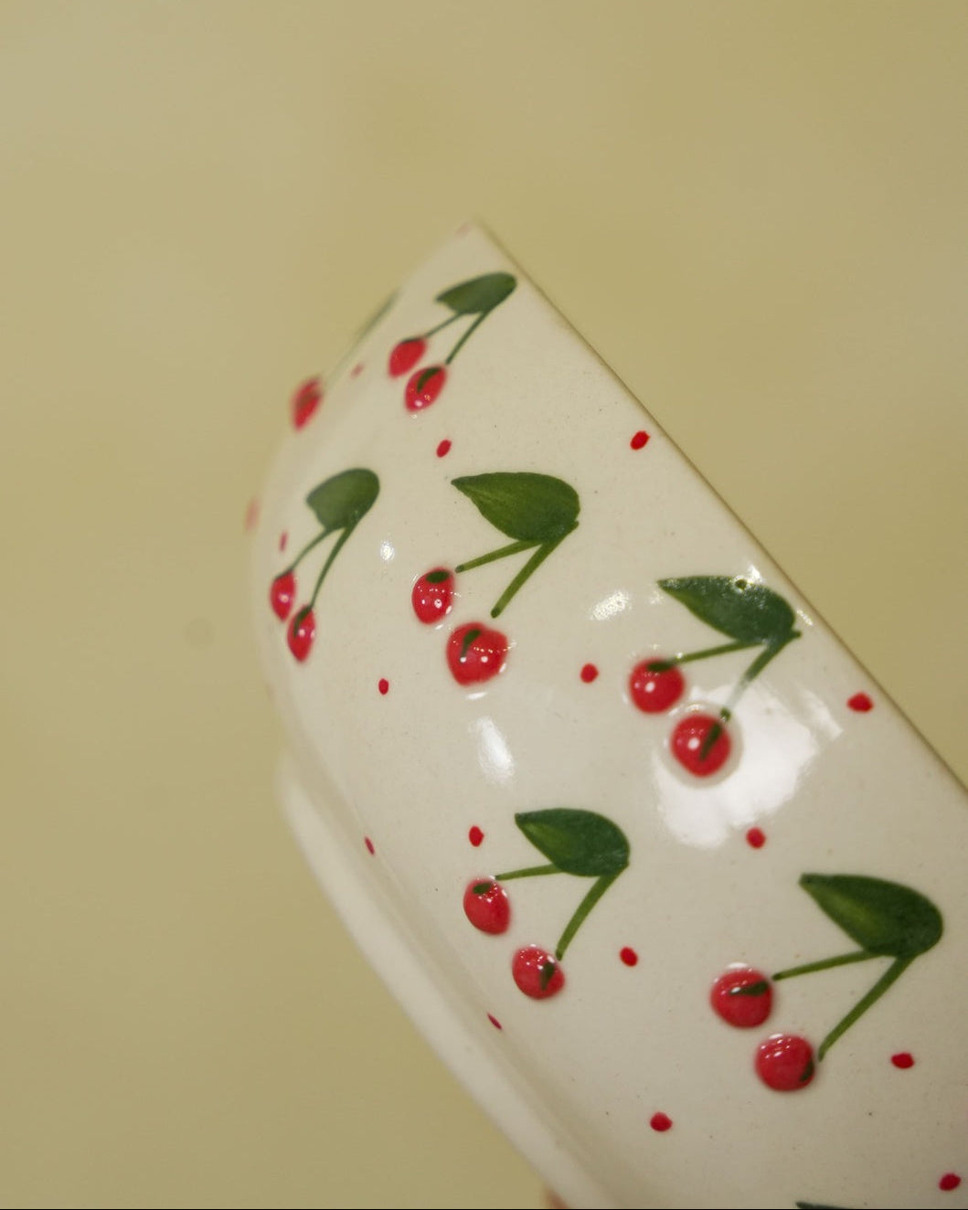 Ceramic mug with cherry design on a beige background